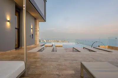 a balcony with benches and a view of the water at Cabrero Centro Del Mar - Cerca de la Ciudad Amurallada in Cartagena de Indias