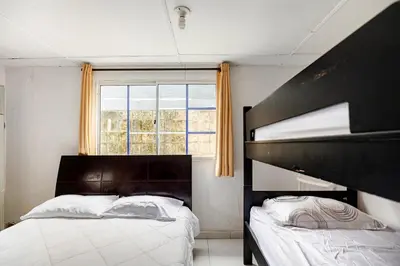 a bedroom with two bunk beds and a window at cabaña villa luz in Santa Veronica