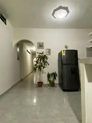 a black refrigerator in a room with two plants at Casa lo amador alojamiento entero in Cartagena de Indias