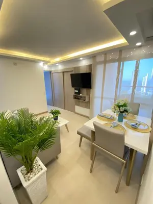 a living room with a table and chairs and a television at Terrazas Vista al Mar y Piscina Espectacular in Cartagena de Indias