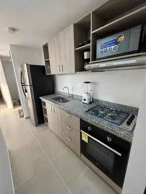 a kitchen with a stove and a refrigerator at Apartamento con balcón grande in Cartagena de Indias