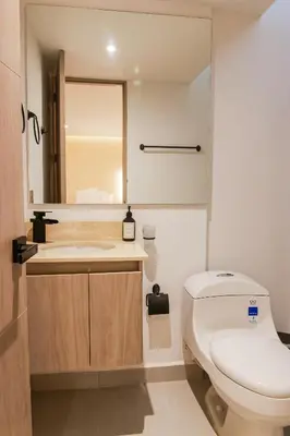 a bathroom with a white toilet and a sink at Dunia Suite in Cartagena de Indias