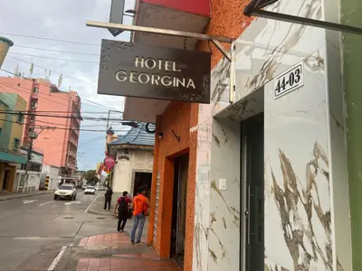 a hotel georgiana sign on the side of a building at Hotel Georgina in Barranquilla