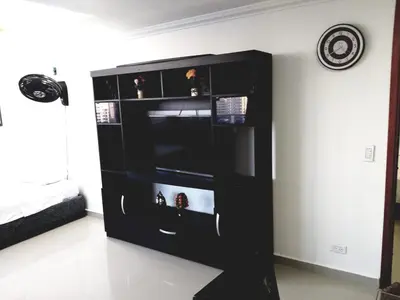 a black entertainment center in a living room at Apartamento Moderno con Vista - Piso 12 in Cartagena de Indias