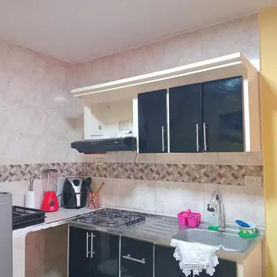 a kitchen with a sink and a stove top oven at comodo apartamento in Barranquilla