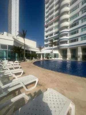 a swimming pool with lounge chairs and buildings at Apartamento con vista al mar Palmetto in Cartagena de Indias