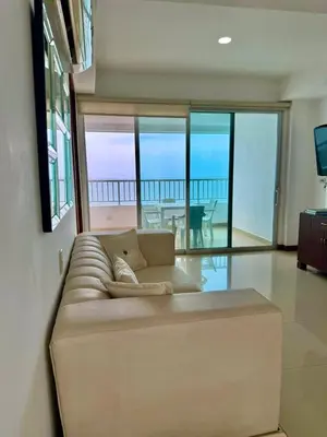 a couch in a living room with a view of the ocean at Apartamento con vista al mar Palmetto in Cartagena de Indias