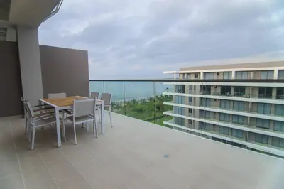 a balcony with a table and chairs and a building at Exclusive Apartment With Ocean View By Huespedia in Cartagena de Indias