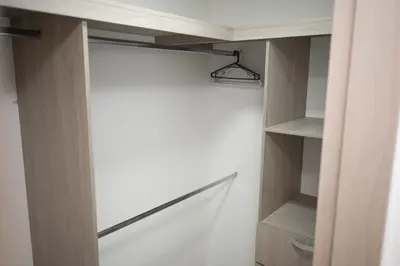a closet with wooden shelves and a light fixture at Apartamento cerca al aeropuerto in Cartagena de Indias