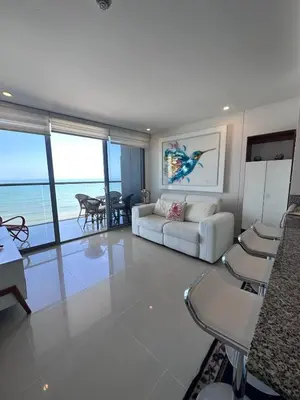 a living room with a couch and a table and chairs at MC 1303- beach front apt- Morros City top location in Cartagena de Indias