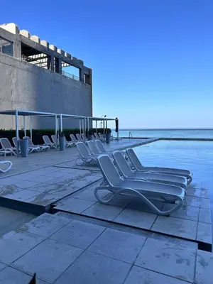 a group of chairs sitting next to a swimming pool at MC 1303- beach front apt- Morros City top location in Cartagena de Indias