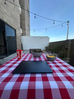 a table with a red and white checkered table cloth at Apartamento Arrecife Golf in Barranquilla