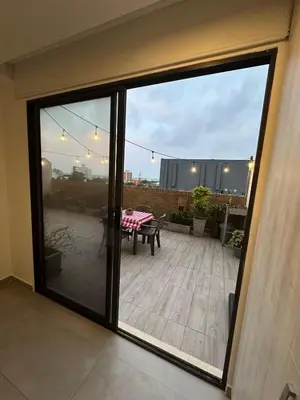 a sliding glass door to a patio with a table at Apartamento Arrecife Golf in Barranquilla