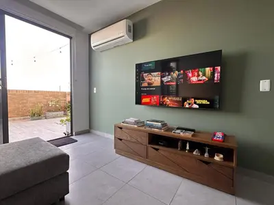 a living room with a flat screen tv on the wall at Apartamento Arrecife Golf in Barranquilla