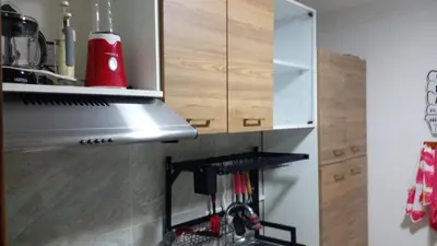 a kitchen with a stove top oven next to a cabinet at Apartaestudio Ciudad Jardin in Barranquilla
