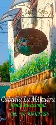 a painting of a building with a sign on it at Cabaña La Makuira in Santa Marta
