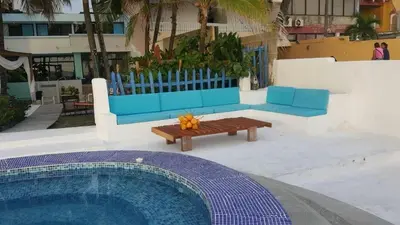a swimming pool with a bench and a table and a bench at Vista al Mar in Cartagena de Indias