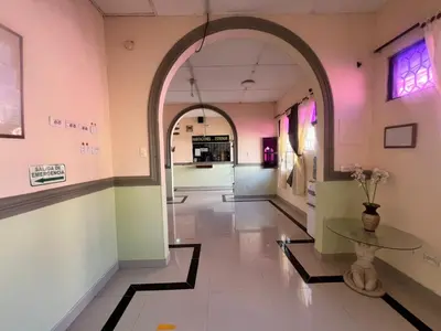 an entrance to a store with an archway and a table at Hotel Don Fermin in Barranquilla