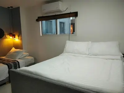 a white bed in a room with a window at Hotel Boutique Tierra Del Mar Cartagena in Cartagena de Indias