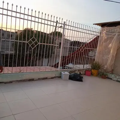 a fence on a balcony with a view of a city at comodo apartamento in Barranquilla