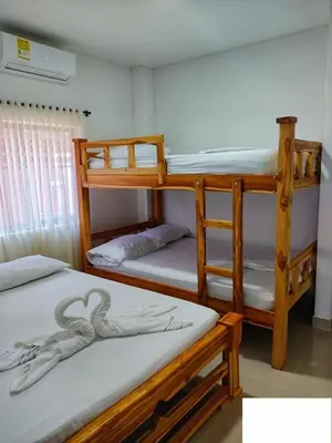 two bunk beds in a room with another bed at Cabaña doña Santi in San Antero