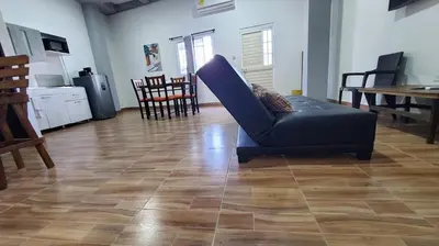 a living room with a blue couch on a wooden floor at Apartahotel hm caribe in Santa Marta