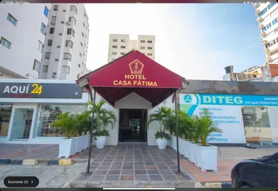 a hotel with a red awning in front of a building at Hotel Casa Fátima in Cartagena de Indias