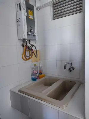 a large sink in a white tiled kitchen at Hermoso Apto playa de Morros! in Cartagena de Indias