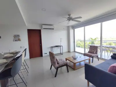 a living room with a couch and a table and chairs at Hermoso Apto playa de Morros! in Cartagena de Indias