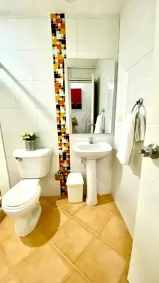 a bathroom with a toilet and a sink at Apartment in Old City Cartagena 3D in Cartagena de Indias