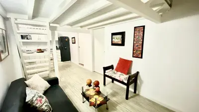 a living room with a couch and a chair and a table at Apartment in Old City Cartagena 3D in Cartagena de Indias