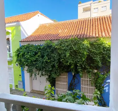 a house with a bunch of ivy growing on it at Apartment in Old City Cartagena 3D in Cartagena de Indias