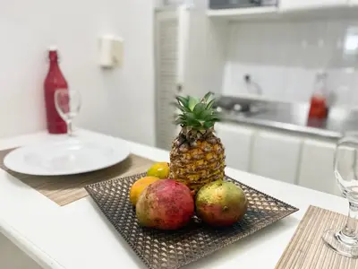 a plate with a pineapple and fruit on a table at Apartment in Old City Cartagena 3D in Cartagena de Indias