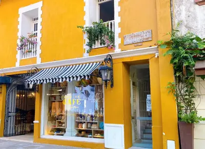a yellow building with a store in front of it at Apartment in Old City Cartagena 3D in Cartagena de Indias
