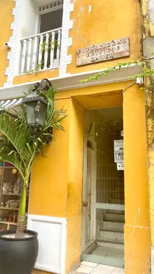 a plant in a pot in front of a building at Apartment in Old City Cartagena 3D in Cartagena de Indias