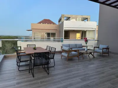 a patio with a table and chairs on a balcony at Baia Kristal Penthouse Cartagena Playa Artificial Más Grande de Colombia in Cartagena de Indias
