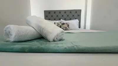 a bedroom with a bed with towels on it at La Boquilla Kite House in Cartagena de Indias