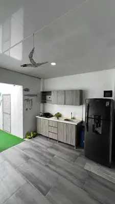 a kitchen with a black refrigerator and a sink at La Boquilla Kite House in Cartagena de Indias