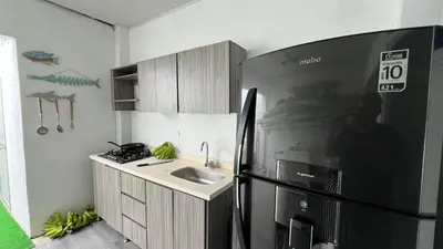 a kitchen with a sink and a refrigerator at La Boquilla Kite House in Cartagena de Indias