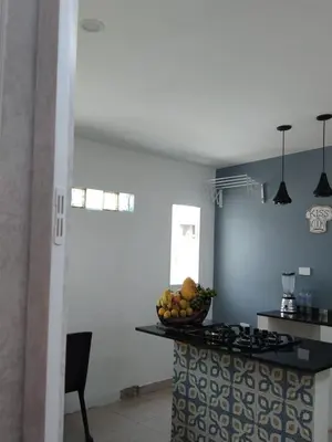a kitchen with a counter with a bowl of fruit on it at Cartagena Hotel Boutique - Manga - Tierra del Mar - Colombia in Cartagena de Indias
