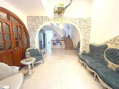 a living room with blue couches and a stone wall at Cartagena Hotel Boutique - Manga - Tierra del Mar - Colombia in Cartagena de Indias