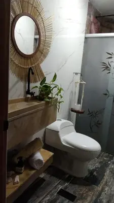 a bathroom with a toilet and a mirror and a sink at Cartagena Hotel Boutique - Manga - Tierra del Mar - Colombia in Cartagena de Indias