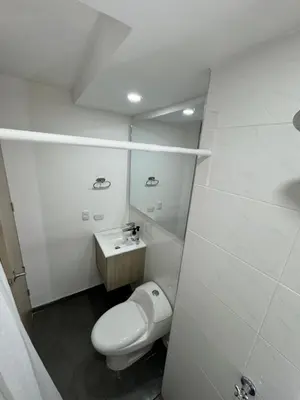 a white bathroom with a toilet and a sink at Apartamento de una habitación en serena del mar en cartagena DAMMAR in Manzanillo del Mar