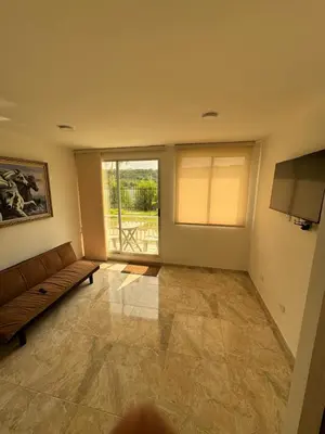 a living room with a couch and a large window at Apartamento de una habitación en serena del mar en cartagena DAMMAR in Manzanillo del Mar