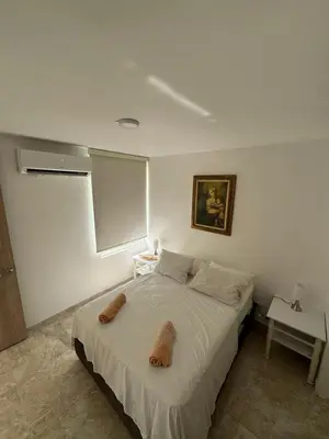 a bedroom with a bed with two stuffed animals on it at Apartamento de una habitación en serena del mar en cartagena DAMMAR in Manzanillo del Mar