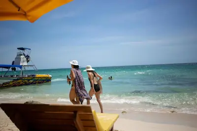 two women walking on the beach near the ocean at Beautiful Cabaña facing the Caribbean Sea! in Cartagena de Indias