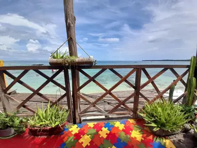 a wooden fence with plants on the beach at Beautiful Cabaña facing the Caribbean Sea! in Cartagena de Indias