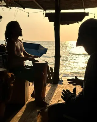 a group of people sitting on a dock near the ocean at Beautiful Cabaña facing the Caribbean Sea! in Cartagena de Indias
