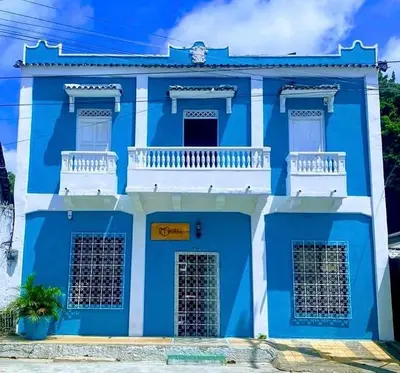 a blue and white building with a white balcony at Casa Turbay in Cartagena de Indias