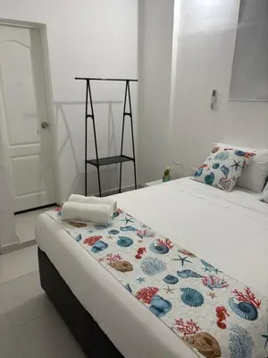 a bedroom with a bed with a blanket on it at Casa Turbay in Cartagena de Indias
